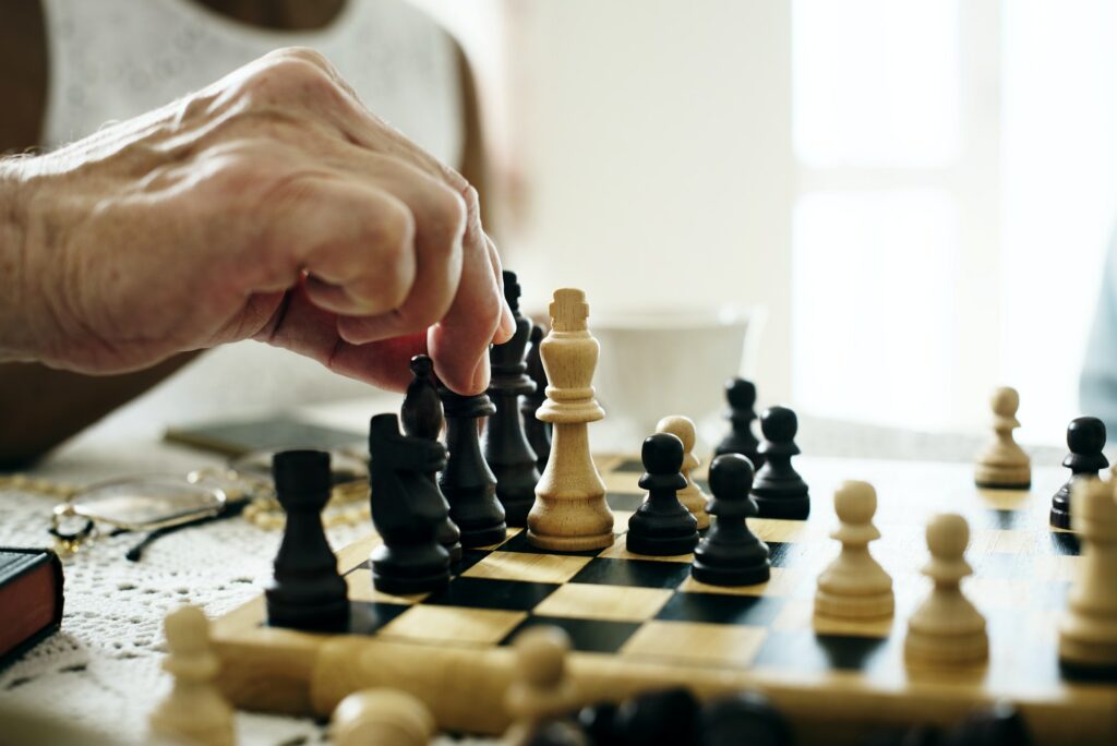 Senior friends playing chess together